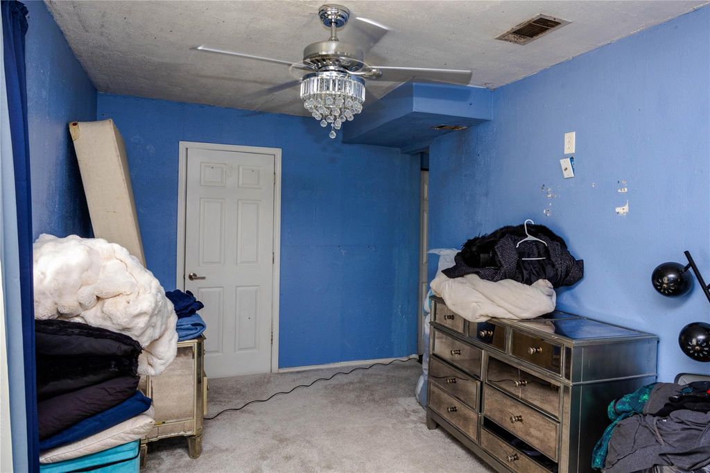 Carpeted bedroom with ceiling fan
