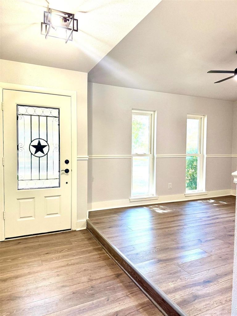 Foyer entrance featuring light wood-style flooring and ceiling fan