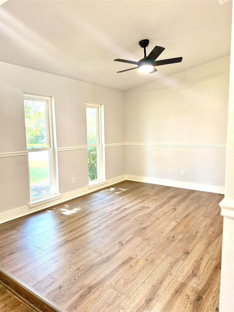 Spare room with light wood-style floors and ceiling fan