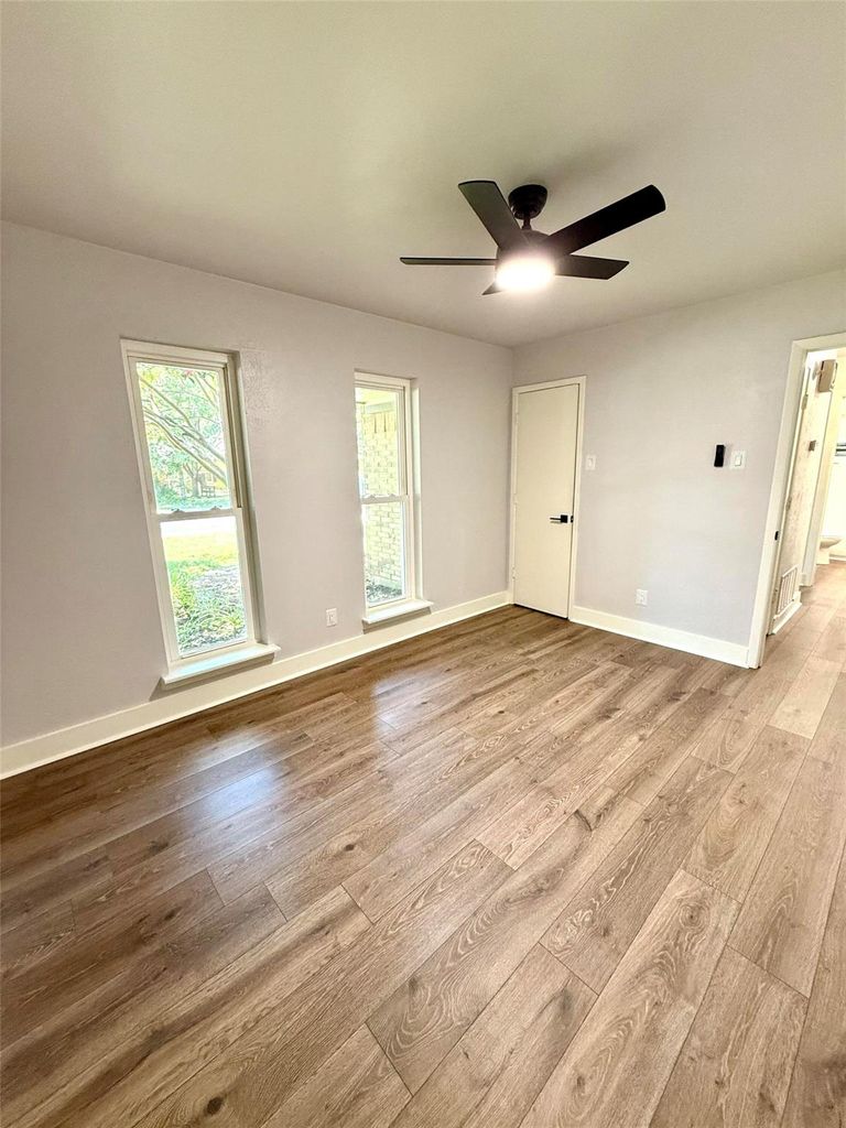 Unfurnished room with light wood-style flooring and a ceiling fan