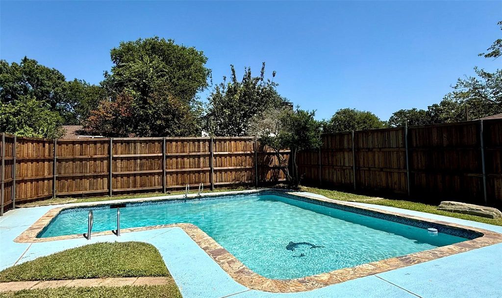 View of pool with a fenced backyard and a patio