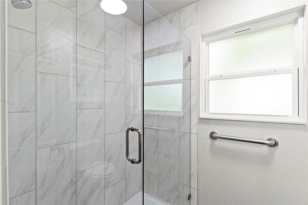 Bathroom with a marble finish shower
