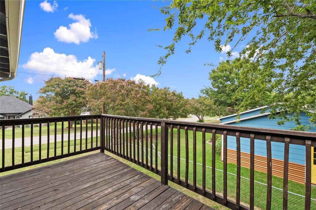 Wooden terrace featuring a lawn