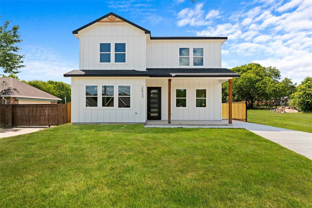 Modern inspired farmhouse with board and batten siding, a porch, and roof with shingles