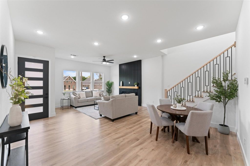 Dining space with recessed lighting, light wood-style floors, ceiling fan, and stairway