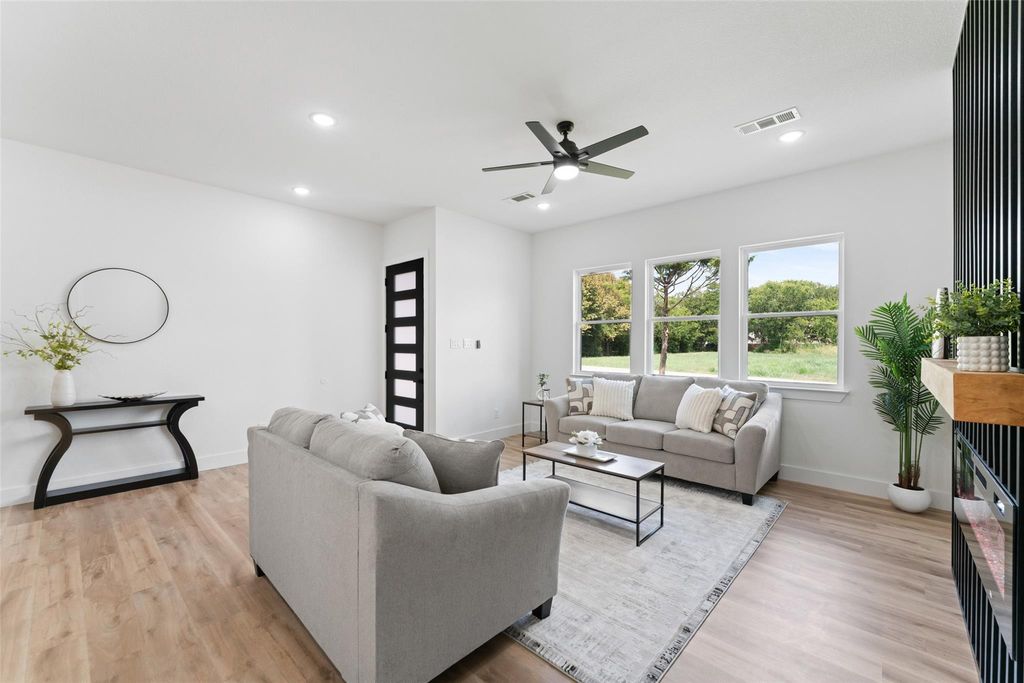 Living room featuring light wood finished floors, recessed lighting, and ceiling fan