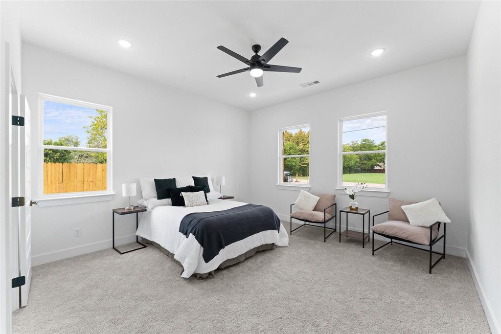 Bedroom featuring light colored carpet, ceiling fan, and recessed lighting