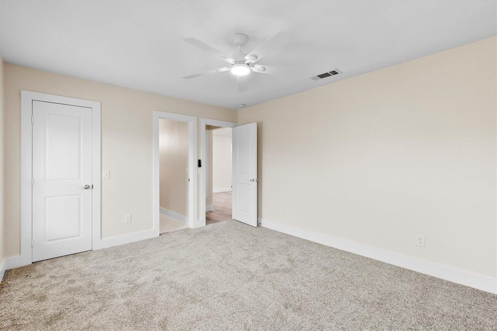 Unfurnished bedroom featuring light colored carpet and ceiling fan