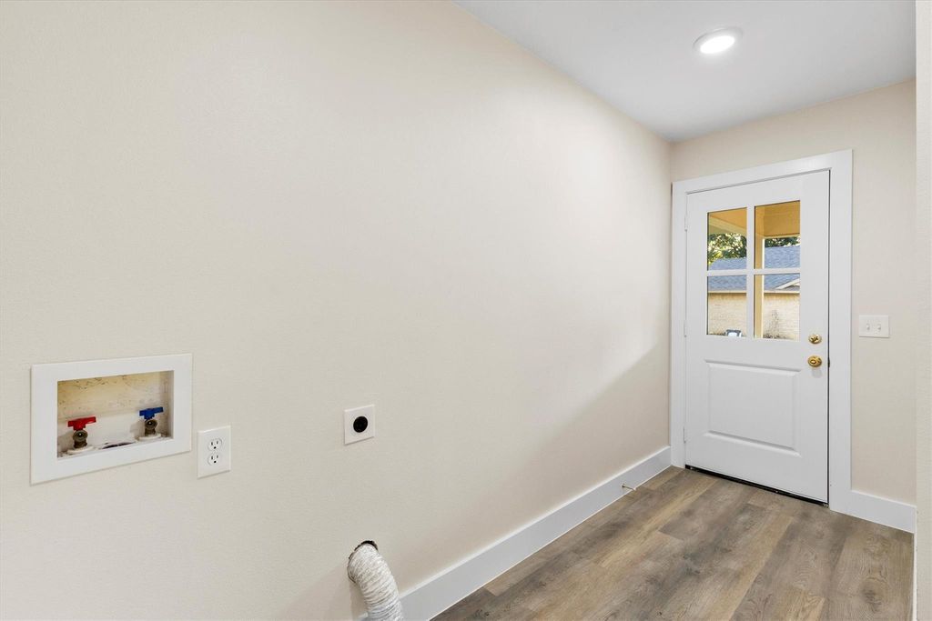 Laundry area with wood finished floors, hookup for a washing machine, hookup for an electric dryer, and recessed lighting