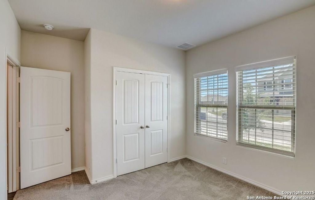 Unfurnished bedroom featuring light colored carpet and a closet