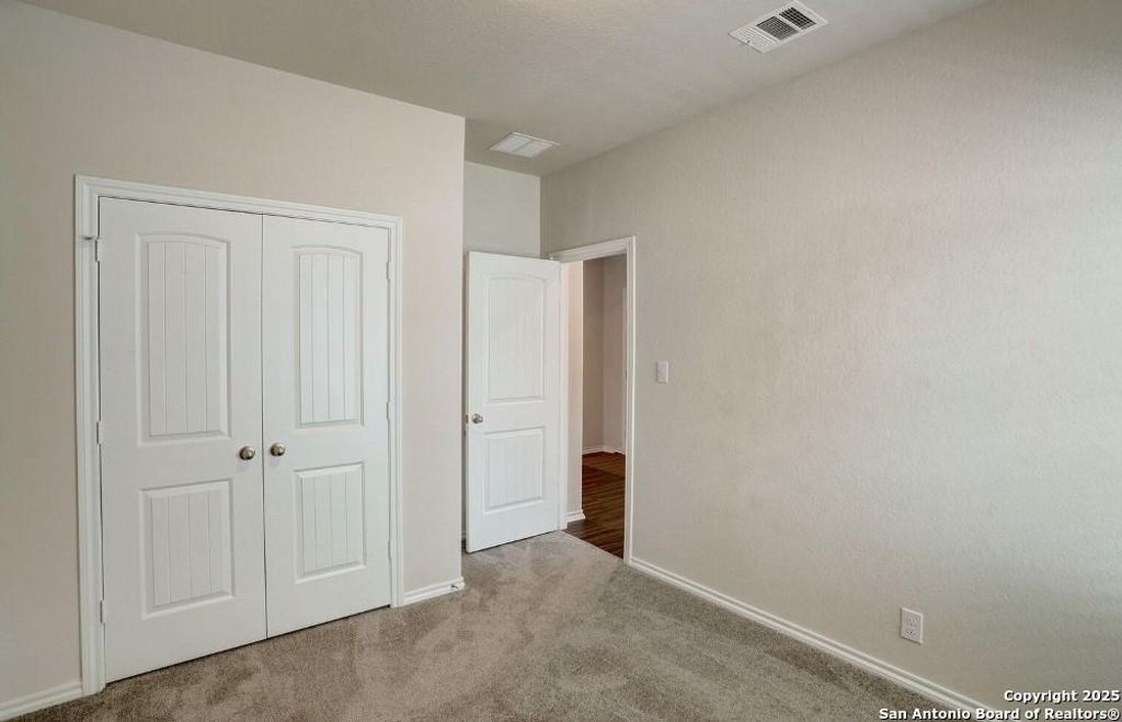 Unfurnished bedroom with carpet and a closet