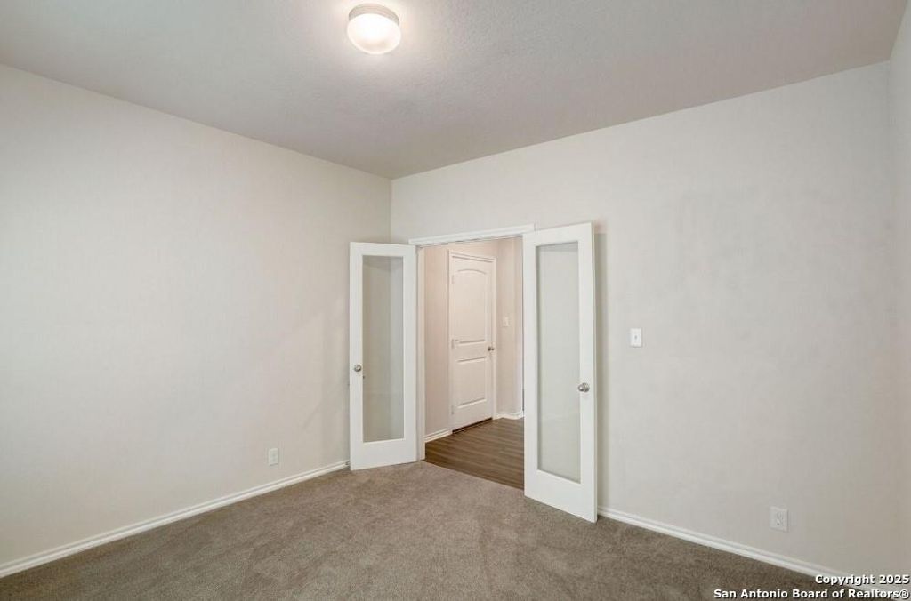 Unfurnished room with carpet floors and french doors
