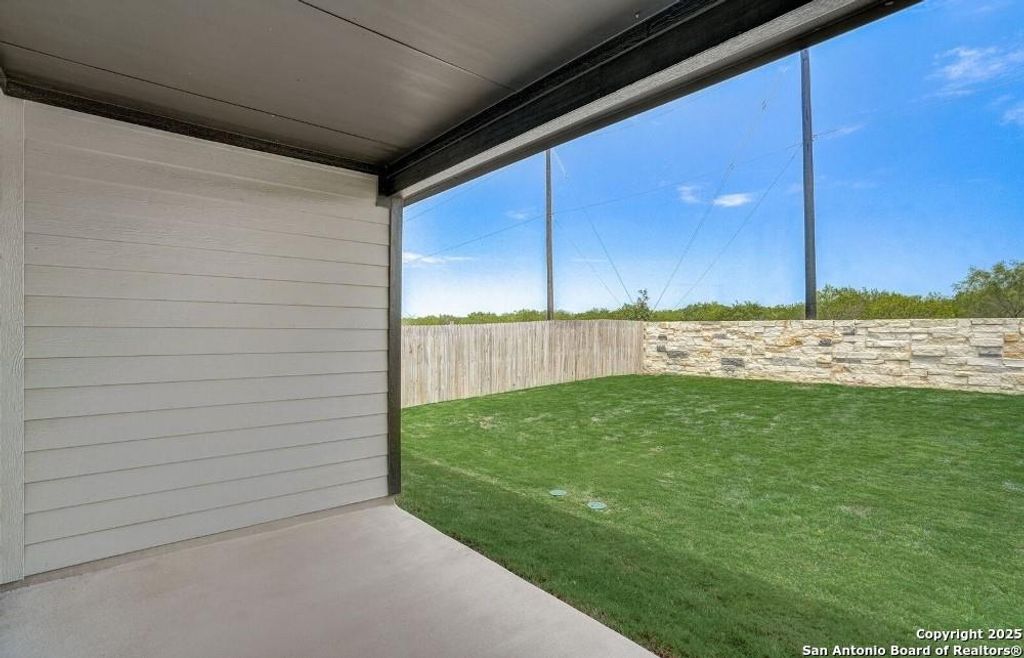 Fenced backyard with a patio
