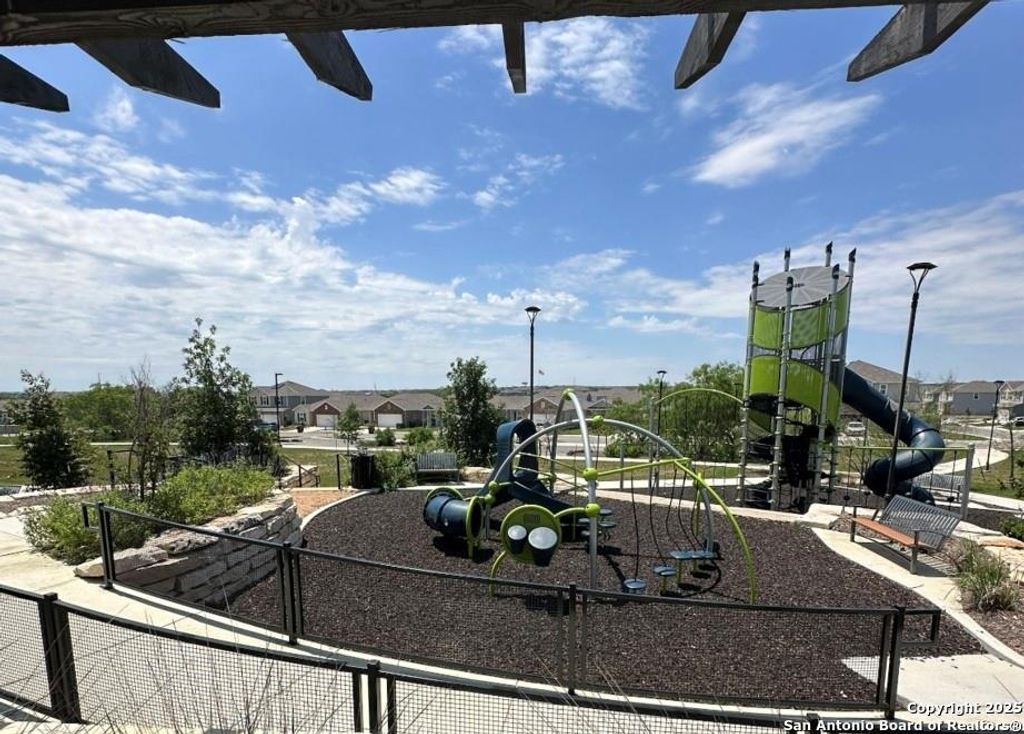 Community jungle gym featuring a residential view