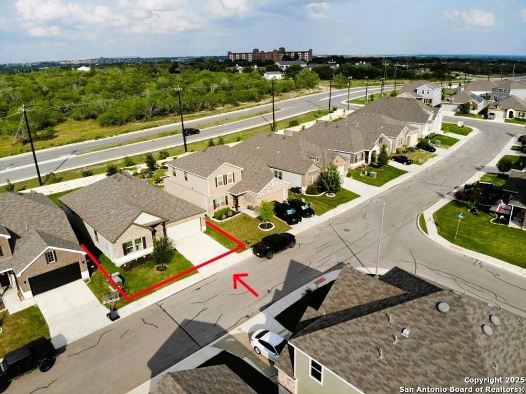 Aerial perspective of suburban area featuring property parcel outlined