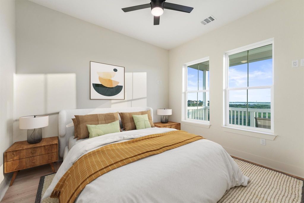Virtually staged bedroom showcasing spacious layout and large windows with serene views. 