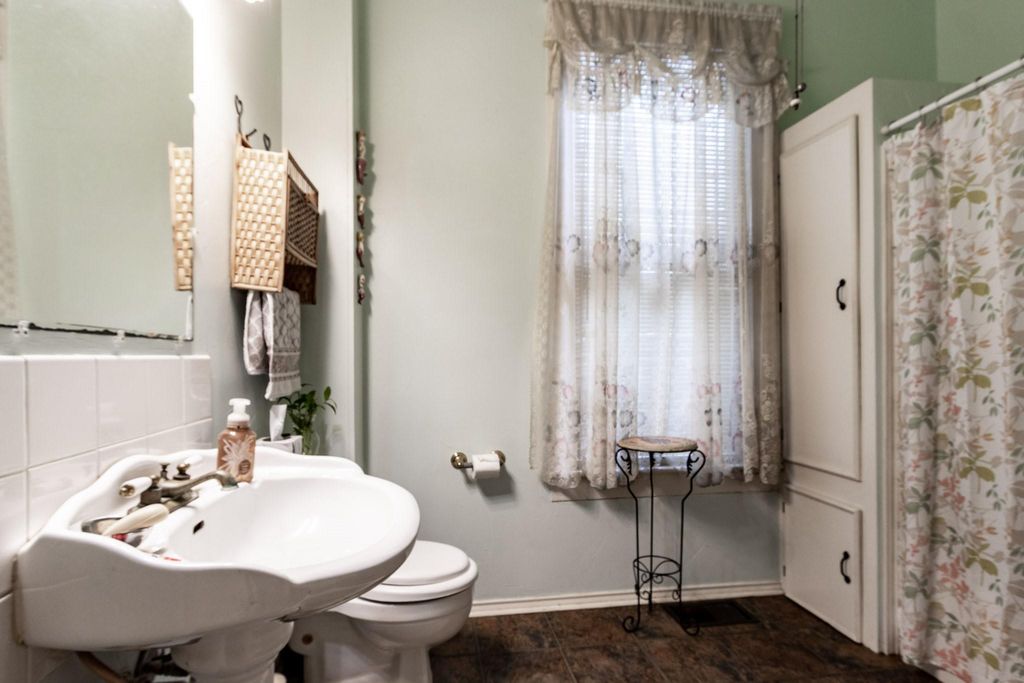 Downstairs bathroom with pedestal sink. 