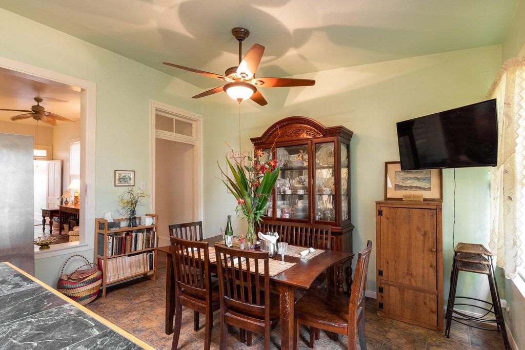 Looking from the kitchen island is the dining area with room for a hutch. Doorway with transom going into the living room. 