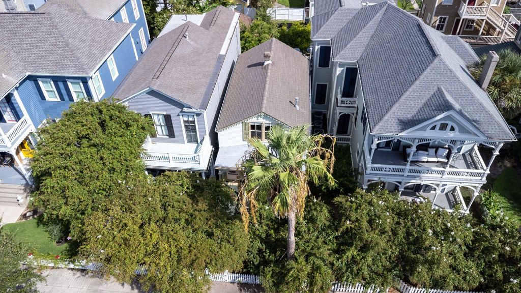 1614 Ball is nestled in its location with lots of flora and a palm tree. 