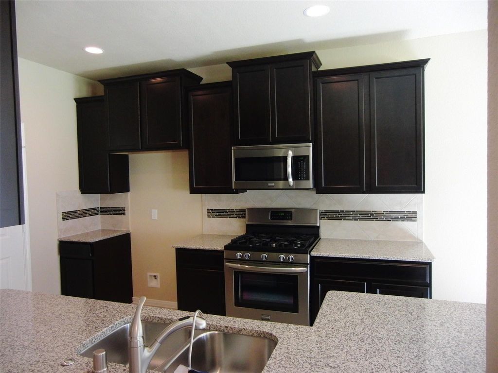 Modern kitchen equipped with all appliances, including a refrigerator.