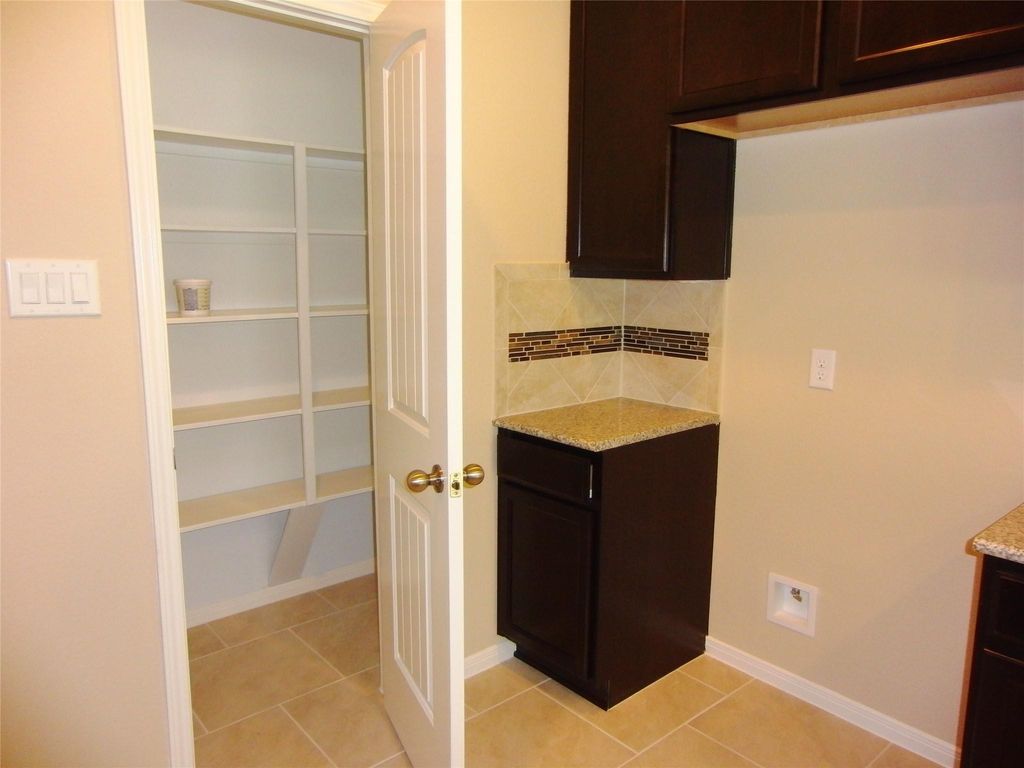 Spacious pantry with ample shelving for organized storage.
