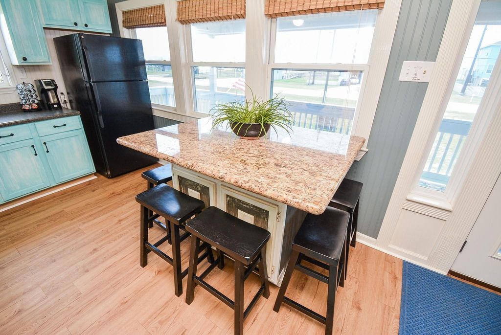 This kitchen features a rolling breakfast island and seating for 6. 