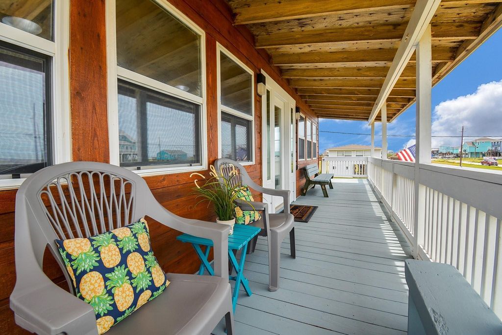 This photo showcases the charming, covered, beach facing deck for relaxing while watching the Gulf of America and enjoying the outdoors.