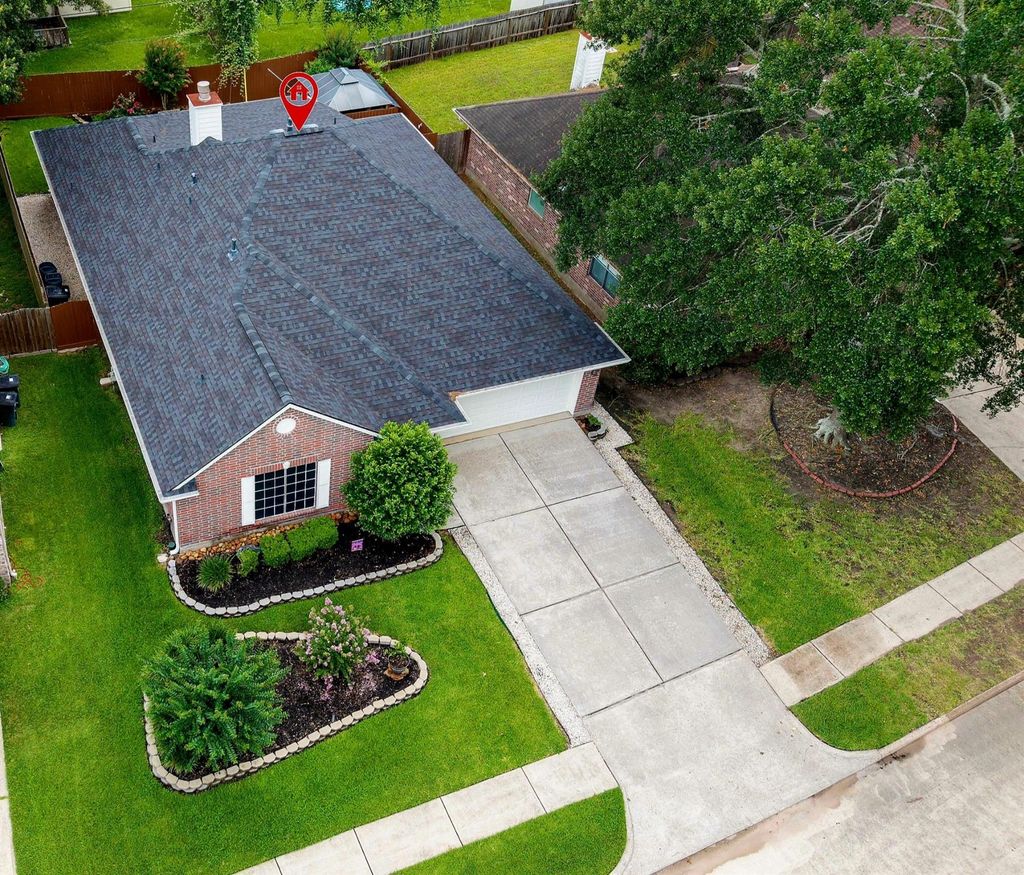 Sweeping views reveal a well-maintained, lovingly cared-for home—from the extended driveway and lush landscaping to the graceful rooflines and more.