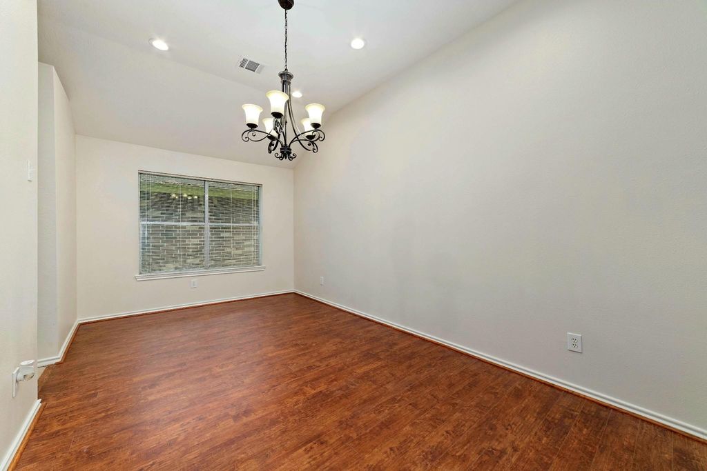 The dining room, adjacent to the kitchen, provides an elegant and inviting space for daily meals and special occasions alike, fostering connection and comfort as guests gather to share food and conversation. 