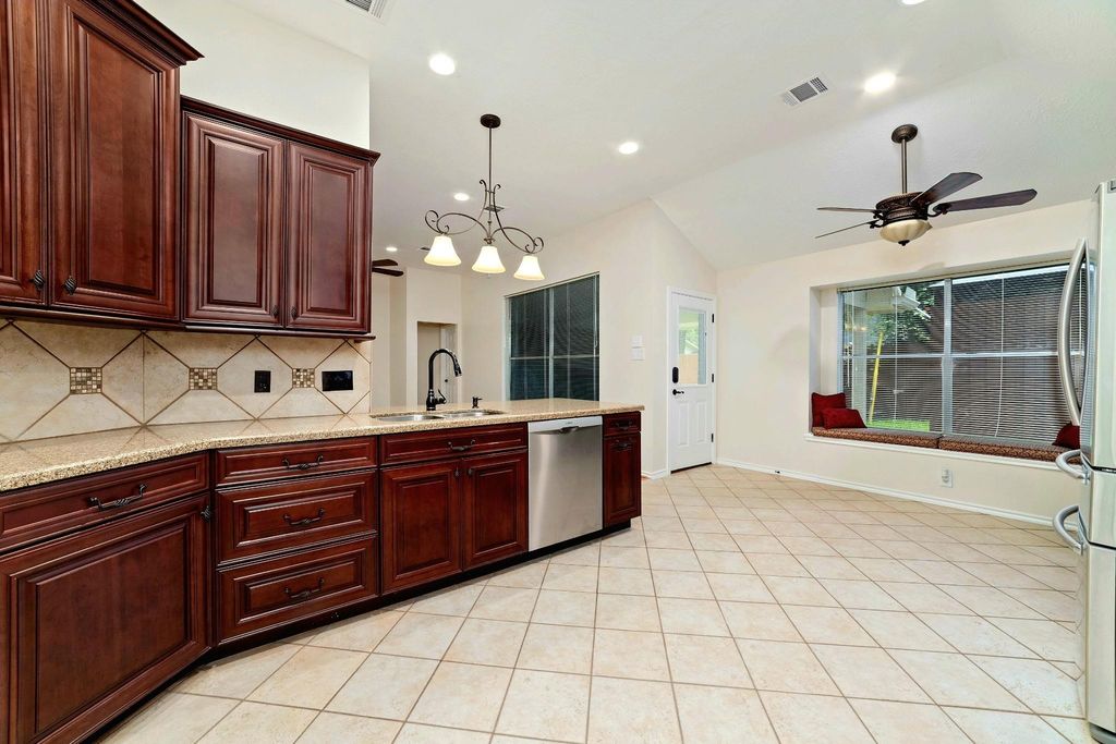 This kitchen is inviting in every sense—where timeless beauty meets effortless function. Elegant warm cabinetry offers abundant space, complemented by classic backsplashes and easy-to-maintain countertops that make everyday living a pleasure.