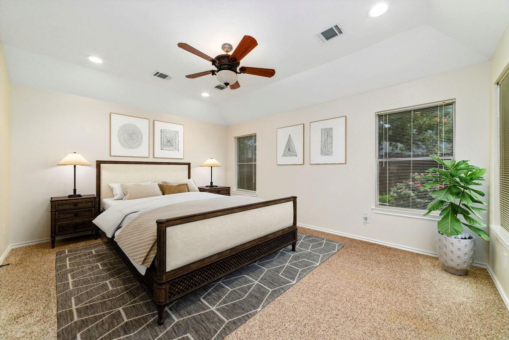 Virtually staged to showcase a bright, spacious primary bedroom and a cozy backyard — imagine the possibilities!
