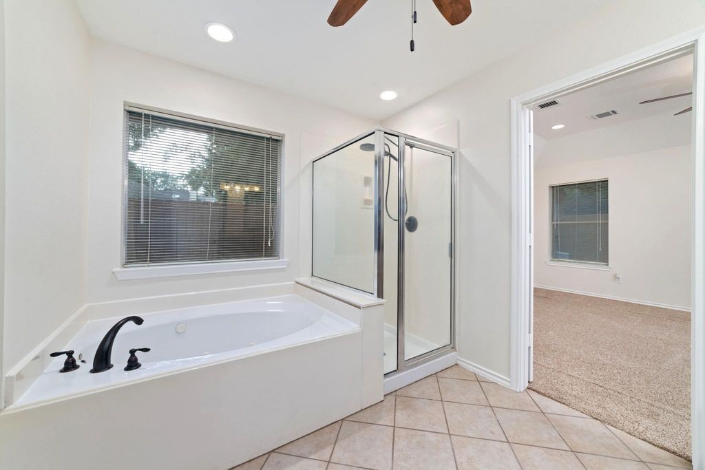 This bathroom offers the choice of a jetted soaking tub for relaxation or a sleek standing shower for a quick, efficient refresh—perfectly suited to any pace of life.