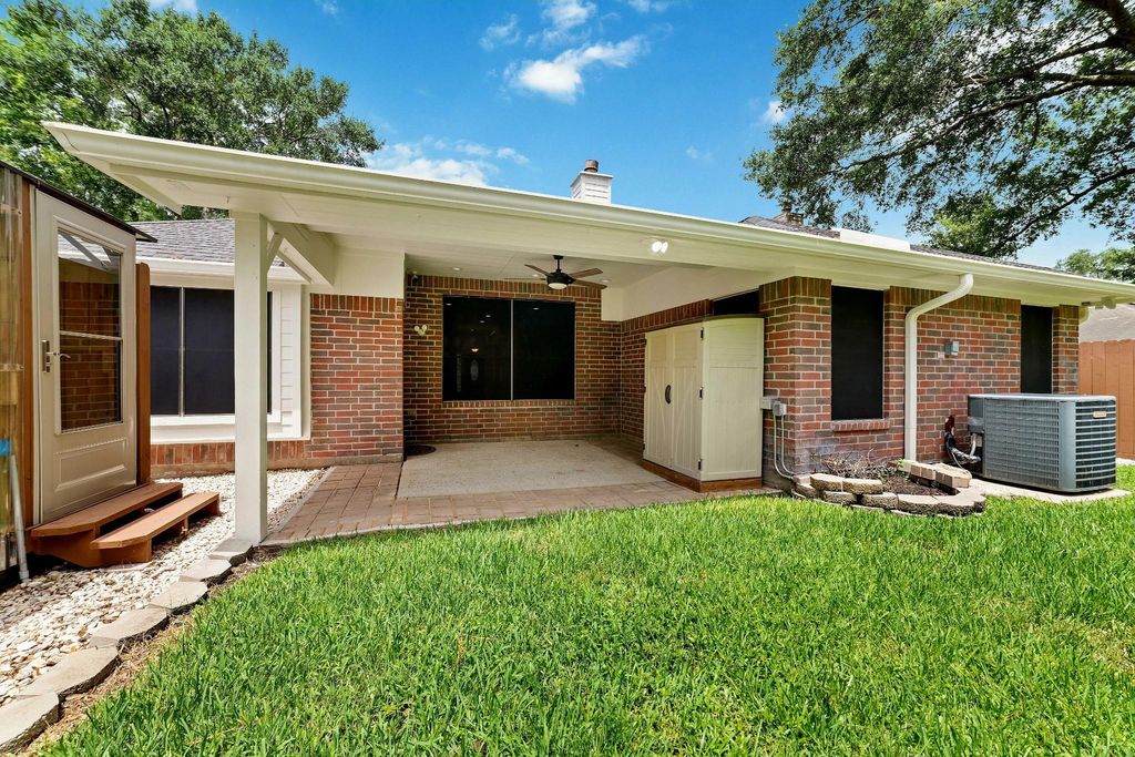 Alternate perspective of the covered backyard patio, showcasing its spacious design and inviting atmosphere for outdoor enjoyment and gatherings.