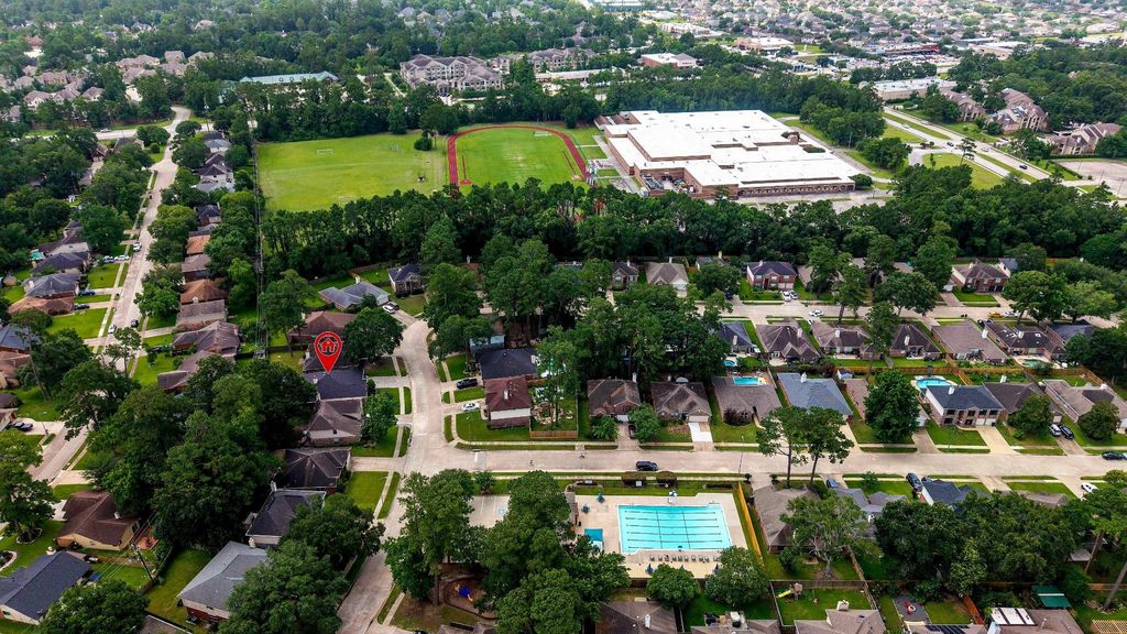 From this elevated vantage point, enjoy sweeping views of the community pool, school, track, and surrounding lush greenery—showcasing vibrant spaces thoughtfully integrated into the landscape. 