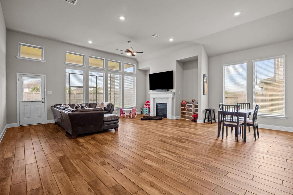 Seamless flow from great room to kitchen with fireplace and backyard views—ideal for gatherings.