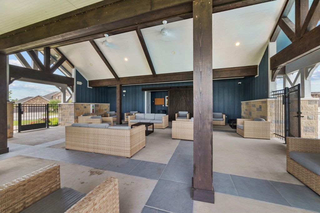 Spacious covered patio at the community pool with access to restrooms 