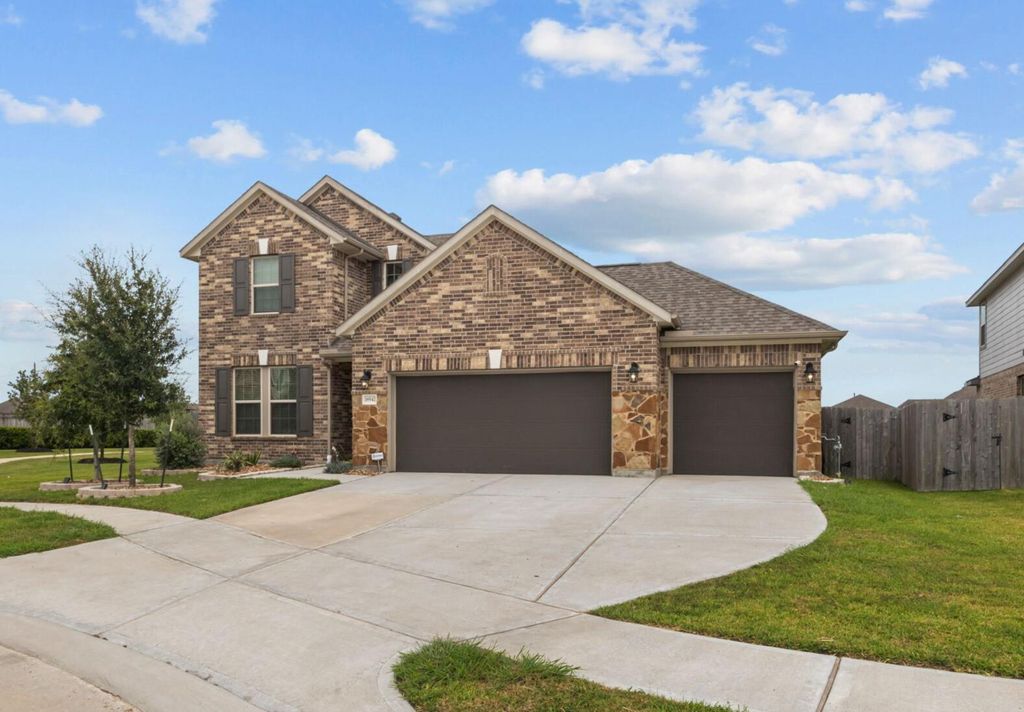 This modern two-story brick home is positioned just across the street from the lake. 