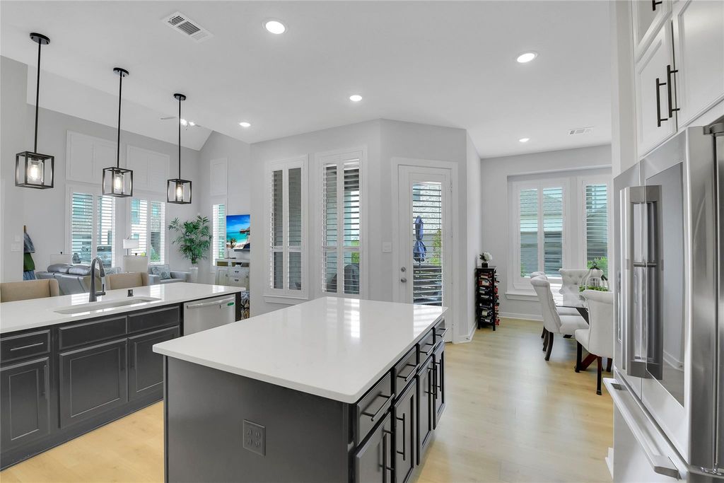 Open design kitchen with plenty of bright recessed lighting.