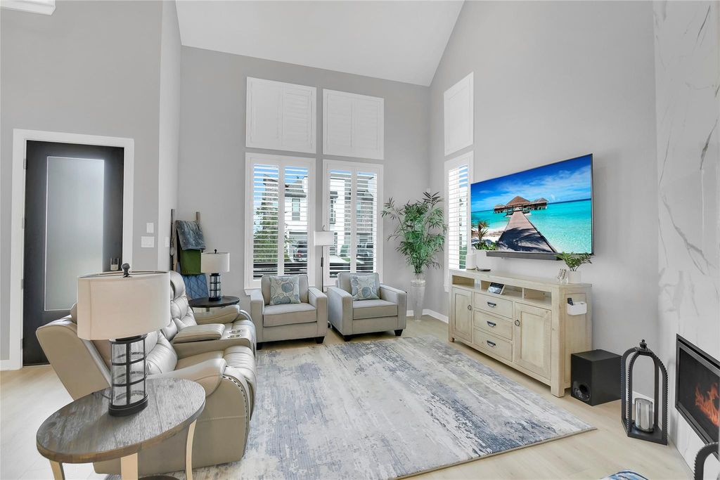Family Room has a soaring vaulted ceiling. This home was upgraded with 8 ft doors on the first floor.