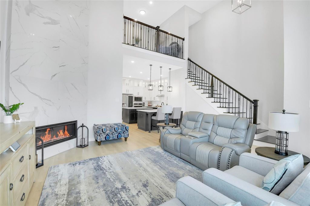 Wood flooring throughout and up the stairs. (tile in bathrooms) Modern wrought iron stair spindles and dark stained newel post.