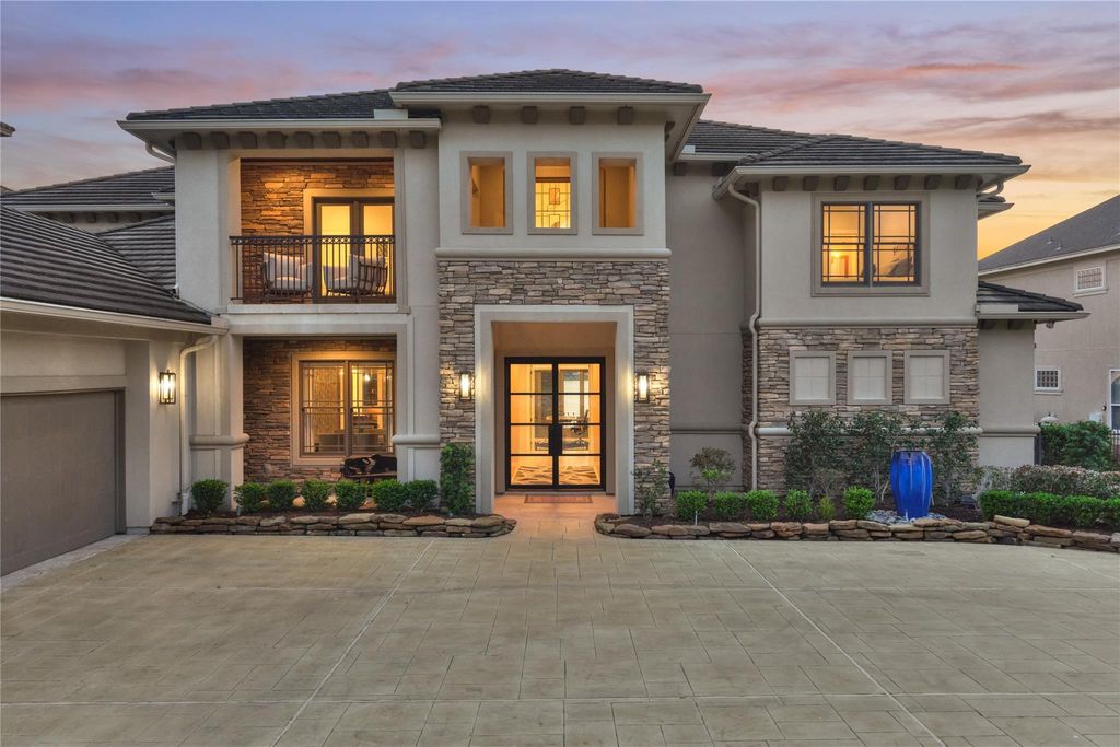 This home enjoys a stamped concrete driveway, a stucco and stacked-stone exterior and custom double front doors to welcome you and your guests. 