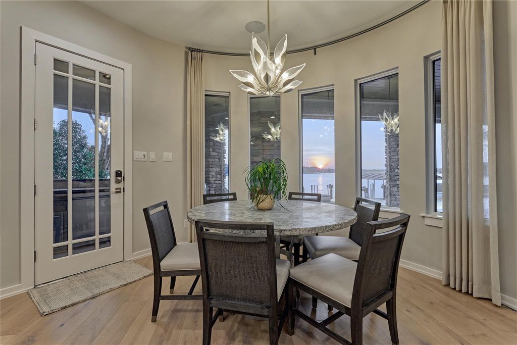 A wall of butte glass windows in the breakfast area provide views of amazing sunsets. Take note of the exquisite light fixture! 