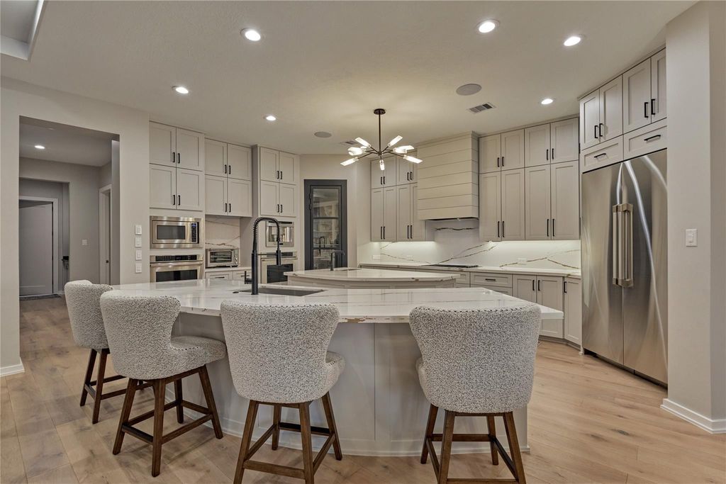 No detail was spared in this culinary oasis. From the modern countertops and backsplash to the chef-grade appliances, even the placement of lighting was thought out carefully. 
