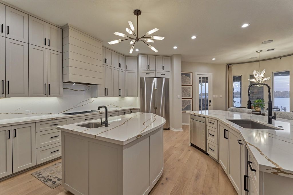 A center island for for food prepping houses a veggie sink and additional storage. 