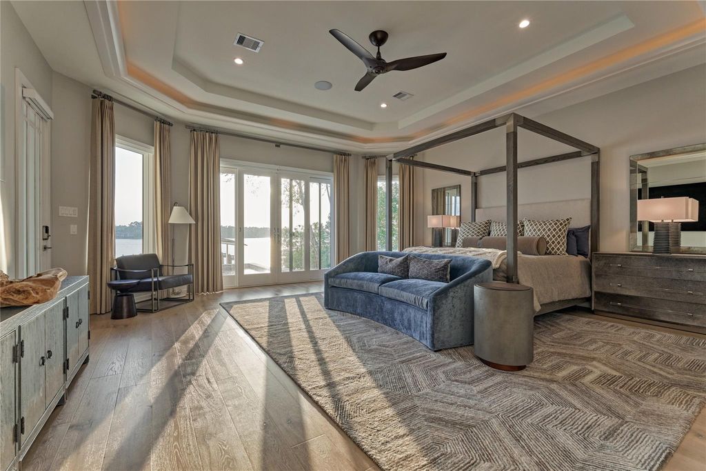 The primary retreat is a spacious peaceful sanctuary overlooking the beautiful Lake Conroe. It features His & Hers closets w/built-in's that include drawers, shelves and hanging space. There is also a wall mounted safe for important documents and valuables. 
