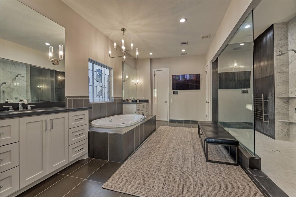 The primary ensuite will allure you with it's spa-like amenities. The soaking tub and dual walk-in shower provide a place of relaxing and rejuvenating at the end of a long day. 