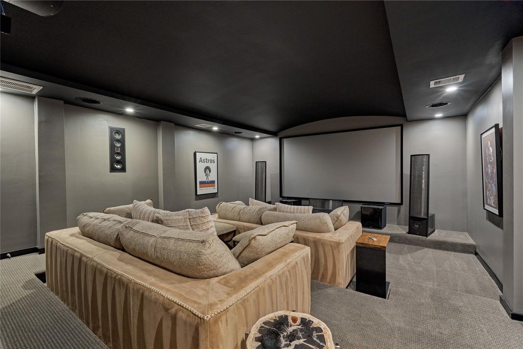 Here we have the media room where family movie night is fun entertainment for all to enjoy!   A Sony 4K Projector and a Denon AV Receiver convey with the home.