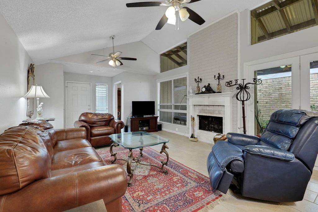 Living area with gas log fireplace.   Sliding doors open to the covered patio. 