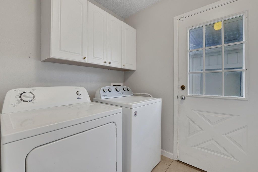 Laundry room with cabinets.